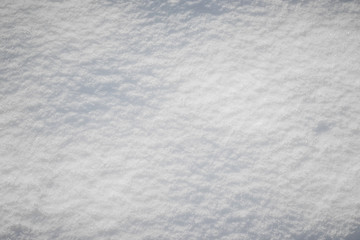 Snow texture with light shadows, winter background