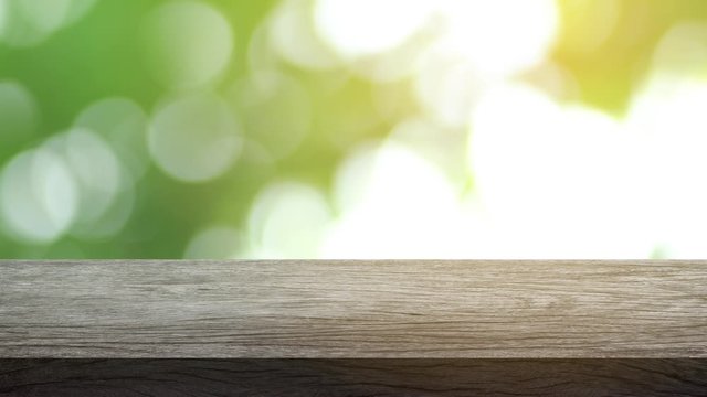 Wood table bar and nature tree bokeh blurred background, Top wood table space area for products shows. 3840x2160. 4K UHD. Video Clip.