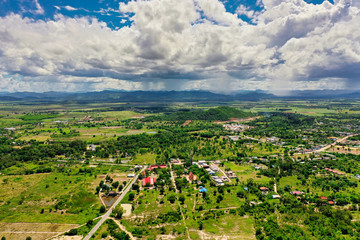 This unique photo shows the landscape of Hua Hin in Thailand and in the background the green mountains with a slightly cloudy blue sky