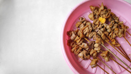 sate usus or chiken intestines satay. traditional indonesian street food