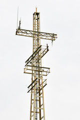 Communications tower on a cloudy sky background