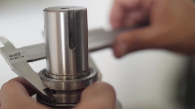 hands working with vernier caliper stainless steel measuring