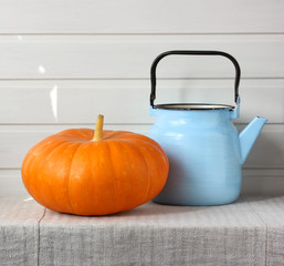 orange pumpkin and blue teapot.