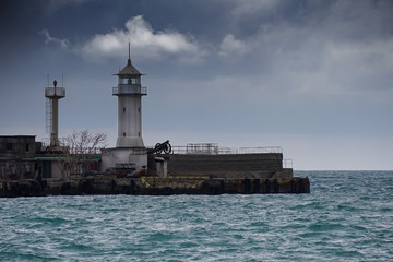 Fototapeta na wymiar Seascape with a view of the white lighthouse.