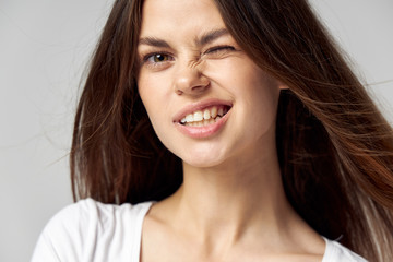 Naklejka premium Woman with closed eye emotions grimace close-up fun 