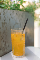 Glass of fresh summer cocktail on the table in cafe with blurred background. Summertime concept.