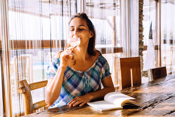 Woman drinking wine at wine bar in vacation.
