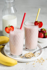 Banana milk smoothie with strawberries and oatmeal. Selective focus
