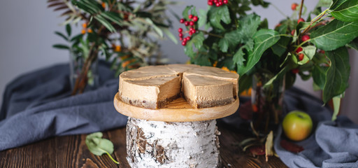 Brown mousse cake without decorations cutted into pieces. Rustic style. Concept of autumn mood and atmosphere