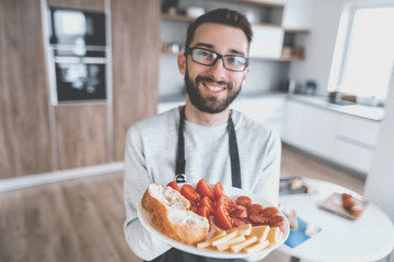 plate of sandwiches in the hands of an attractive man