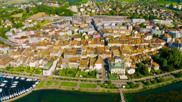 Red Roof Houses And Buildings Of Morges By The Lake Leman  On A Sunny Day In The Swiss Canton Of Vaud, Switzerland - aerial drone (pullback)