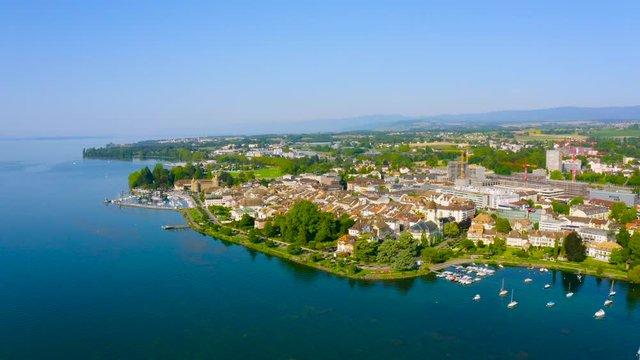 Picturesque Landscape and Architecture Of Morges Town On The Shores Of Lake Leman, Switzerland - Aerial shot (panning)