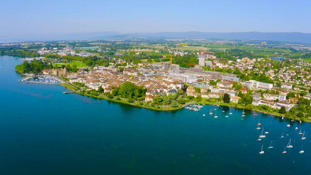 Sailboats Sailing At The Lake Geneva Near The Morges Town During Summer In The Swiss canton Of Vaud, Switzerland - aerial drone