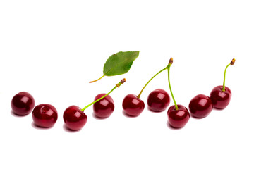 Wishnf isolated on white background. Fresh cherries with green leaves.