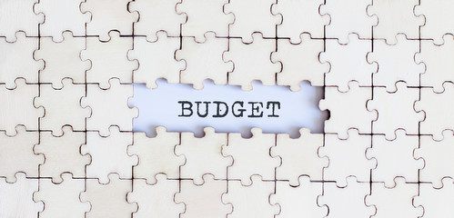 BUDGET .Business concept. White puzzle pieces with different phrases on the white background, top...