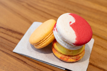 Close-up Colorful biscuit macaroons on wooden table.
