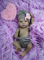 The little ethnic reborn doll girl in pink 