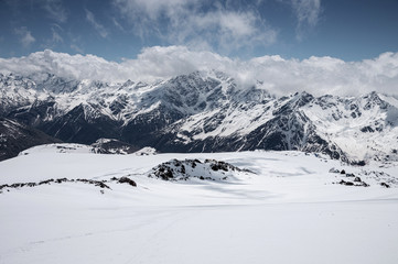 Fototapeta na wymiar Panorama Winter snow-capped mountain peaks in Europe in the North Caucasus. Great place for winter sports. fresh snow and volcanic rocks