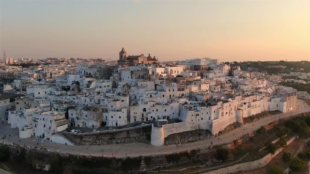ostuni old city at sunset aerial view drone fly forward apulia italy