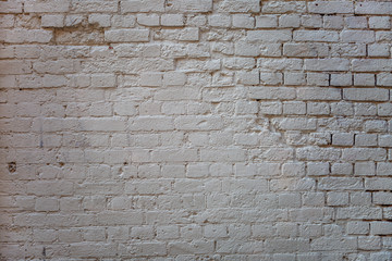 Old light brick wall with broken bricks. Space for text. Background.
