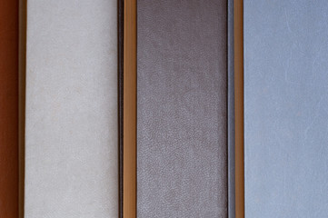 Fototapeta premium Old Books Background. Top view of retro book covers in beige, gray and blue colours