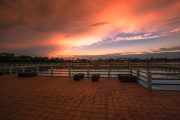 The blurry abstract background of the morning sky by the reservoir and there is a walkway to watch nature for exercise or rest while traveling.