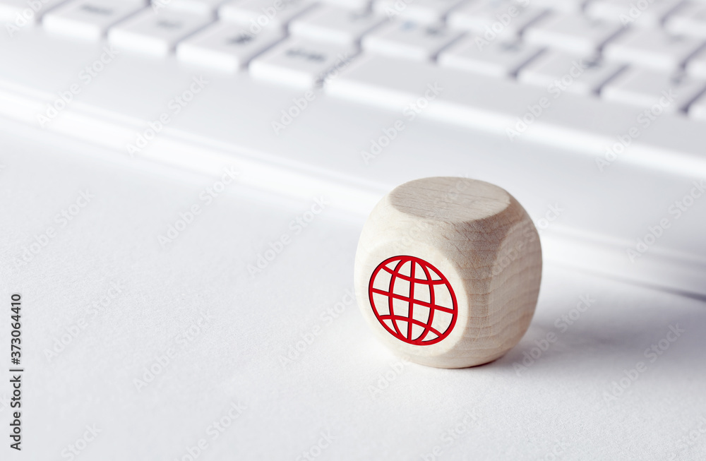 Aufkleber internet or www, world wide web icon or symbol on a wooden cube with computer keyboard background