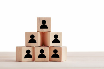 Wooden blocks with employee icon on white background. Leadership, human resources management,...