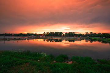 The blurry abstract background of the morning sky by the reservoir and there is a walkway to watch nature for exercise or rest while traveling.