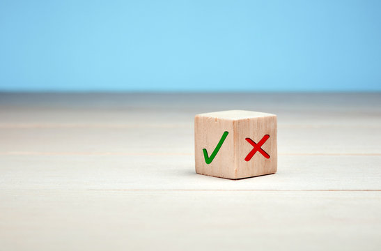 Wooden Block With Green Check Mark And Red X. Choice And Decision Making Concept.