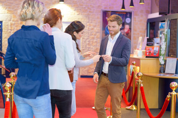 friends queuing at the cinema lobby