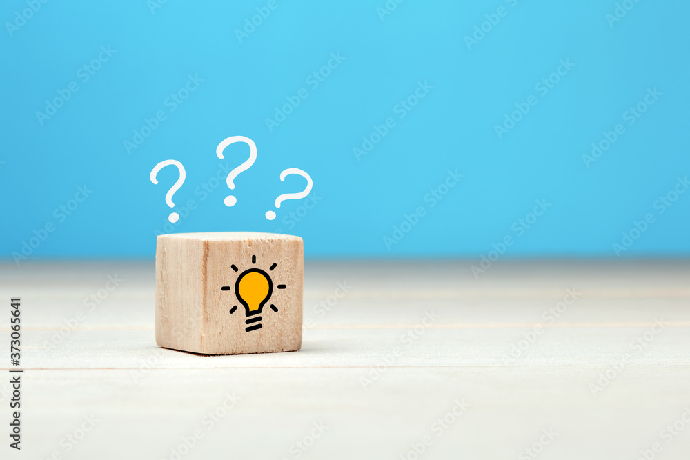 Poster concept of to find a creative idea or problem solving. question mark and light bulb icons on wooden 