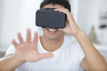 attractive man wearing virtual reality goggles