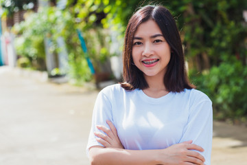 Naklejka premium Portrait of Asian teen beautiful young woman smile have dental braces on teeth laughing outdoor, Medicine and dentistry concept