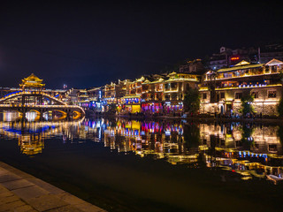 Fototapeta premium fenghuang,Hunan/China-16 October 2018:Tourist walking with beautiful Scenery view in the night of fenghuang old town .phoenix ancient town or Fenghuang County is a county of Hunan Province, China