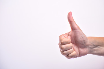 Hand in shows thumb up gesture on white background. man's hand giving it's ok sign. Copy space.