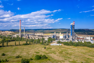 Fototapeta na wymiar Aerial view from drone of cement factory. Industrial landscape of cement factory.