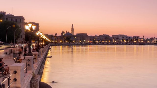 bari city old town timelapse day to night,people walking on the promenade,apulia italy