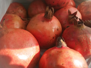 Pomegranate fruit from top angle showing its ends.