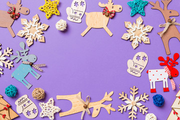 Festive decorations and toys on purple background. Merry Christmas concept with copy space