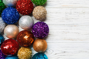 Festive composition of decorative baubles on wooden background. Top view of Christmas toys with copy space
