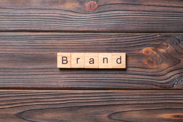 brand word written on wood block. brand text on table, concept
