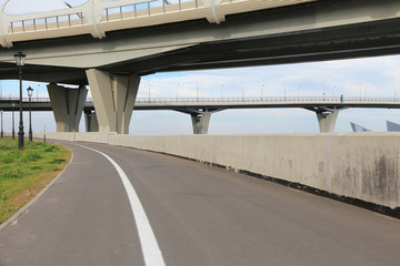 Bike path under bridges. Modern urban infrastructure for cyclists and pedestrians