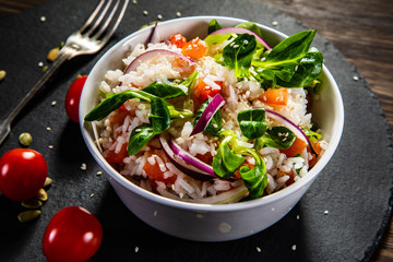 White rice and vegetables on wooden table