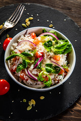 White rice and vegetables on wooden table