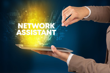 Close-up of a touchscreen with NETWORK ASSISTANT inscription, innovative technology concept