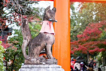 Fox sculpture in Fushimi Inari-taisha shrine in fall autumn season, located in Fushimi-ku. landmark and popular for tourists attractions in Kyoto