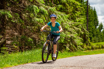 Fototapeta premium Healthy lifestyle - teenage girl biking in forest 