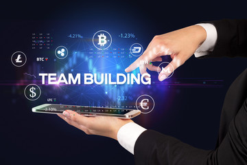 Close-up of a touchscreen with TEAM BUILDING inscription, business opportunity concept