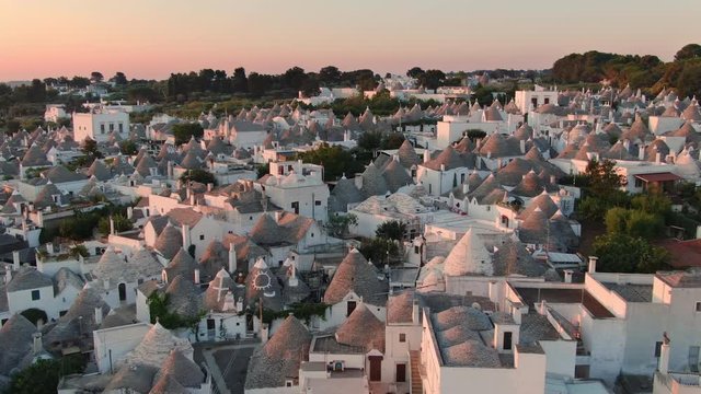 aerial view of trulli of alberobello town apulia,drone fly over old town buildings at sunrise italy